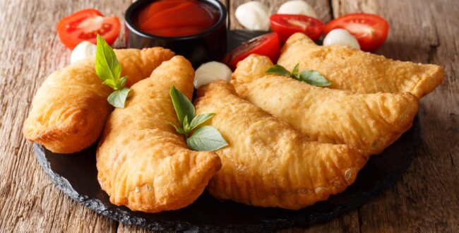 Hot Fried Panzerotti With A Filling Of Tomatoes, Herbs And Mozza
